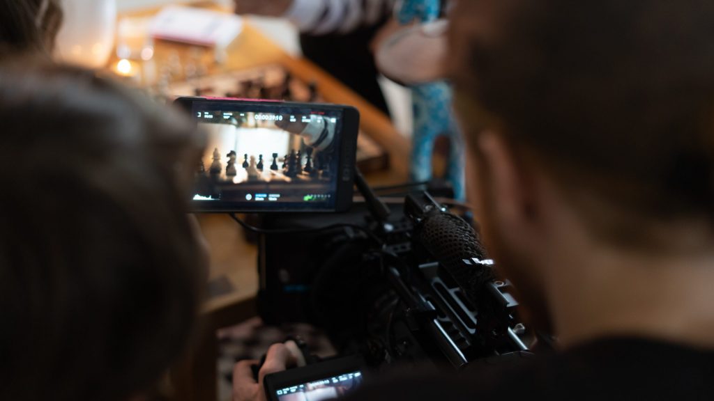 small businesses branded content video top tips, man looking at camera screen